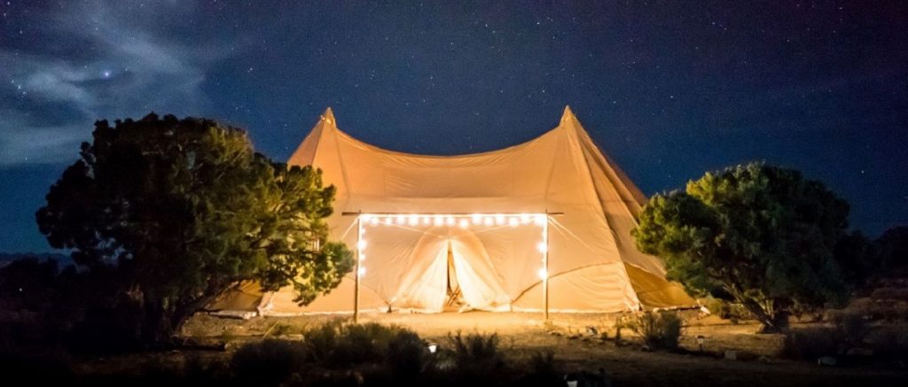 image of glamping with lights around the tent entrance